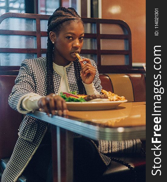 Photo of a Woman Eating at the Restaurant