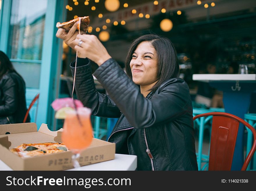 Photo Of Woman Holding Pizza