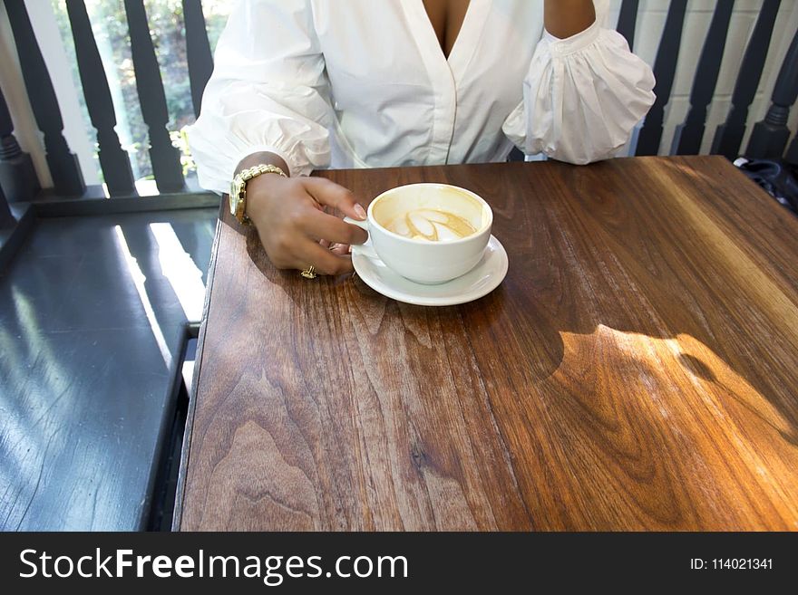 Photo of Person Holding Cup of Coffee