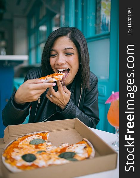 Photo of Woman Eating Pizza