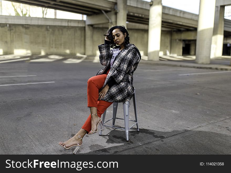 Photo of Woman Sitting in the Middle of the Road