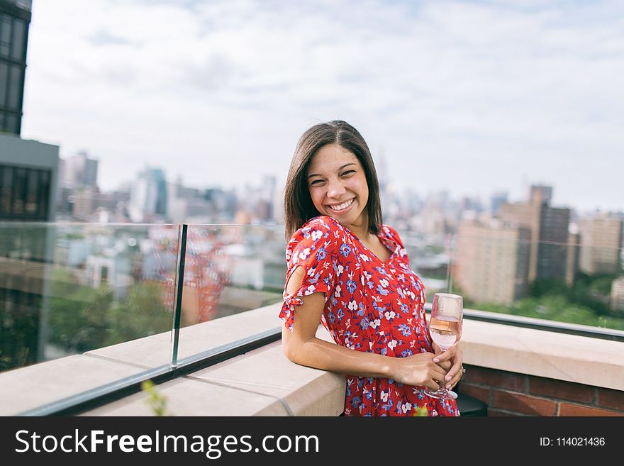 Woman Wearing a Floral Dress with the a Rooftop View