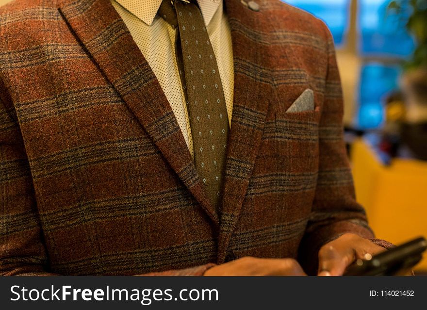 Person Wearing Red and Gray Plaid Suit Jacket