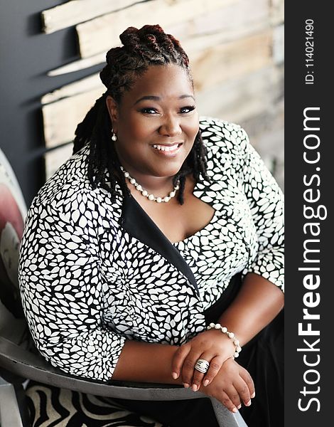 Smiling Woman Sitting On Chair