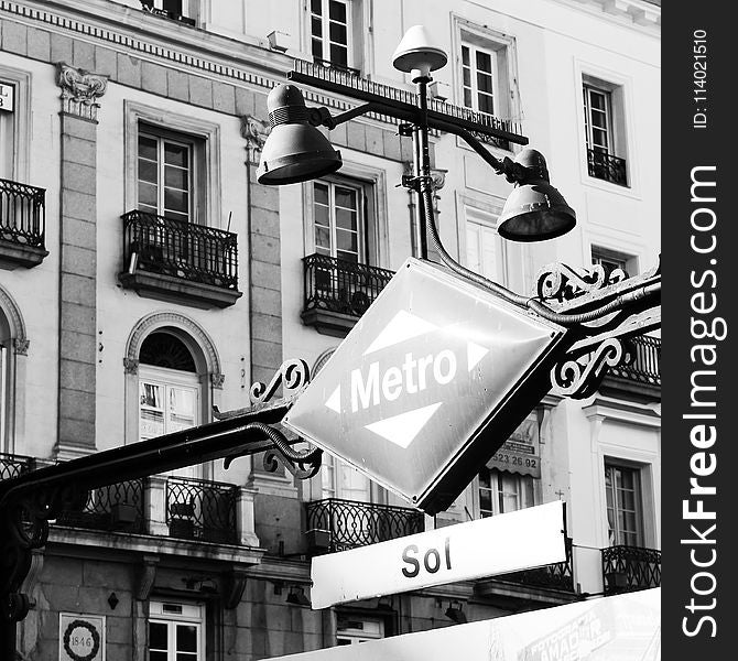 Grayscale Photography of Patio Light and Sign