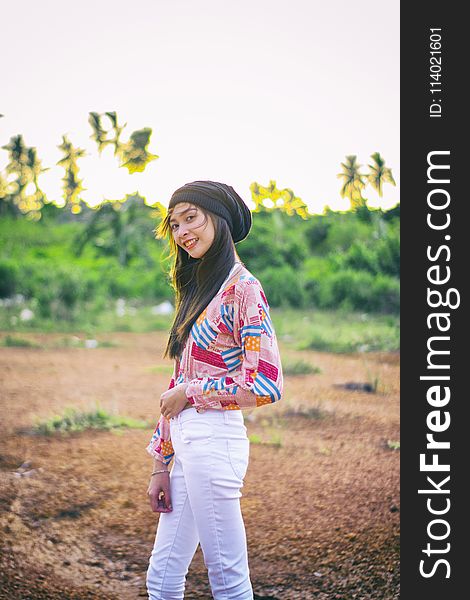 Woman Wearing Black Beanie Standing on Brown Soil Field