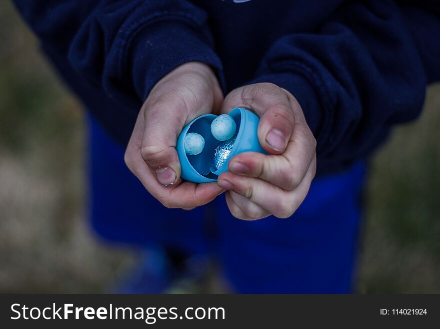 Blue Easter Treats In A Child`s Hands