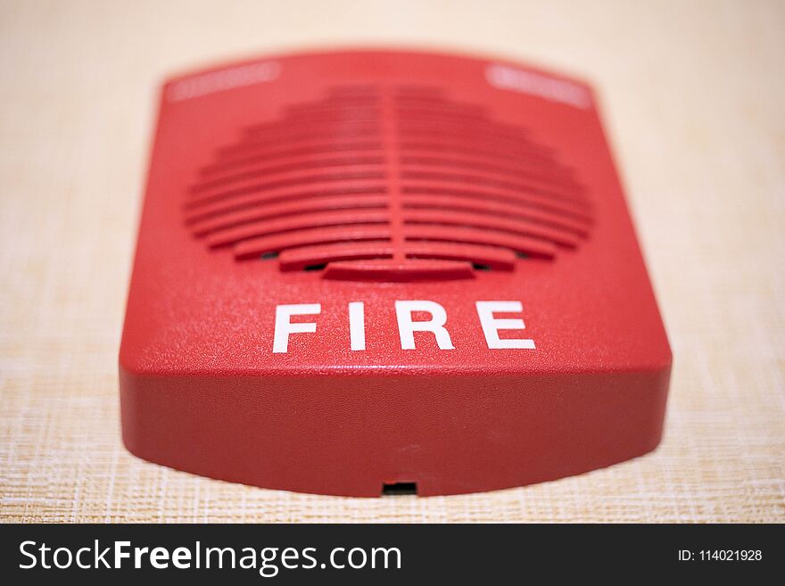 Square red fire alarm on the wall
