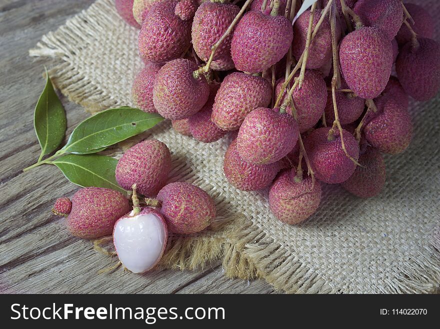 Litchi, lichee, lychee, or lichi, Litchi on sackcloth on old wooden background