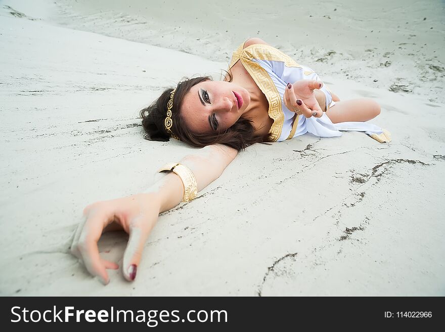 Young Pretty Woman In Greek Tunic On Sand