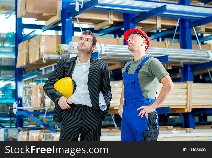 In the factory- young boss and worker in conversation