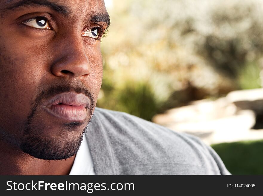 Young African American man looking sad.