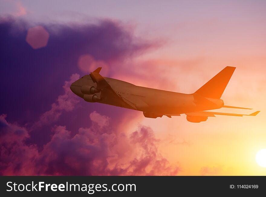 Silhouette of a plane flying in Beautiful sunset. Silhouette of a plane flying in Beautiful sunset.