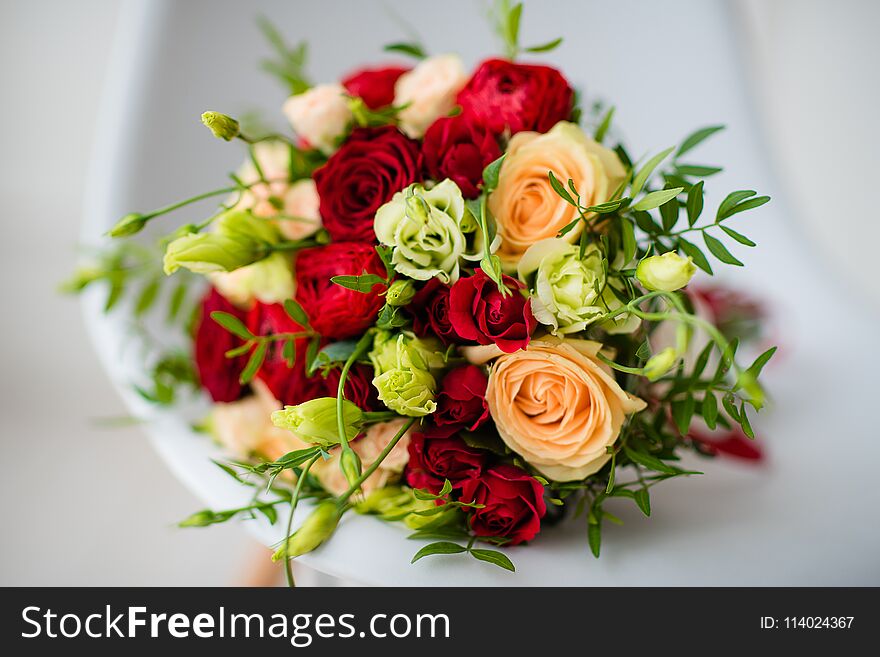 Bridal bouquet of red roses, with red satin ribbons