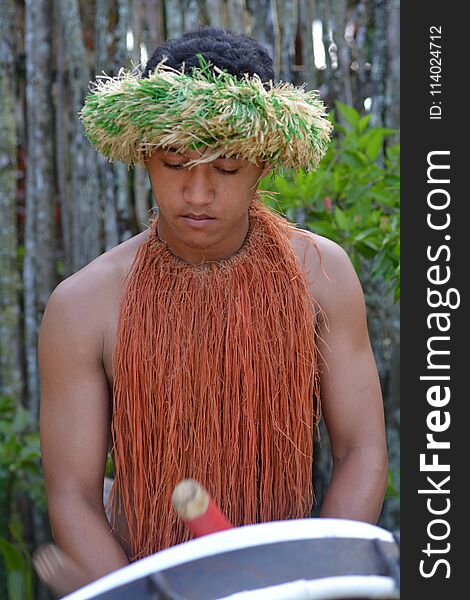 Cook Islander man plays music on a large drum instrument in Rarotonga, Cook Islands. Real people. Copy space. Cook Islander man plays music on a large drum instrument in Rarotonga, Cook Islands. Real people. Copy space