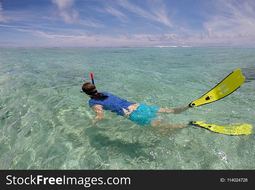 Young woman snorkelling in a lagoon in Rarotonga Cook Islands