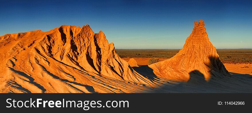 Inland Australia desert landscape in late afternoon winter light. Three image stitched panorama. Inland Australia desert landscape in late afternoon winter light. Three image stitched panorama