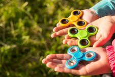 Three Childrens Hands Hold The Spinners Together Stock Photos