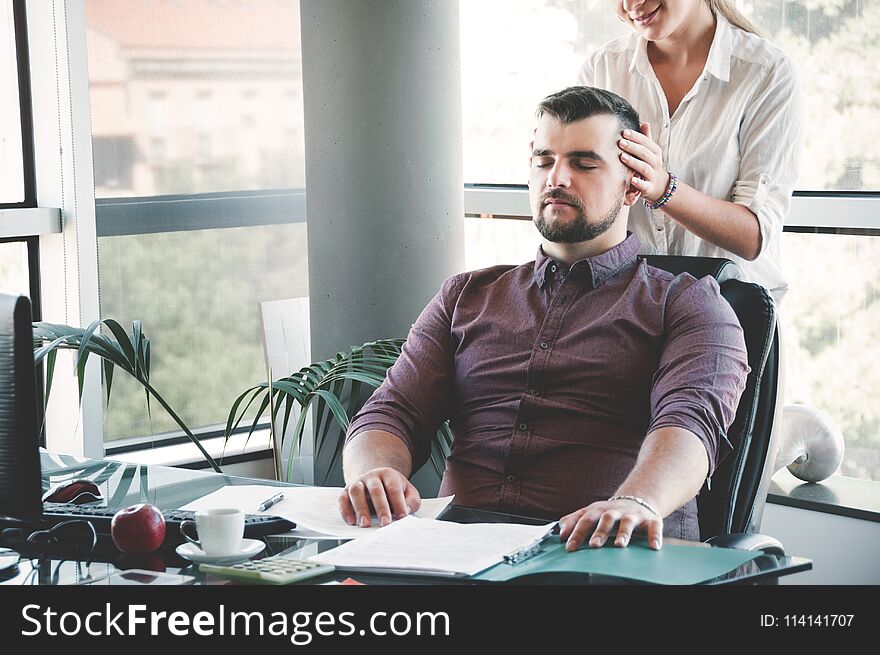 Businesswoman massaging shoulders to colleague at office. Office