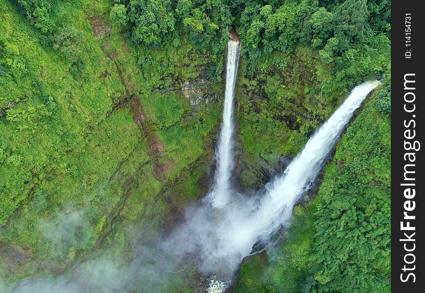 Beautiful waterfall.Tad Fan Waterfall in southern Laos.It is a place to visit the natural beauty.Mountain forest waterfall landscape.Top view,Aerial view,waterfall amazing nature background,Rainforest