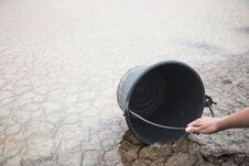 Woman Hand Are Scooping Water On Cracked Ground. Royalty Free Stock Photography