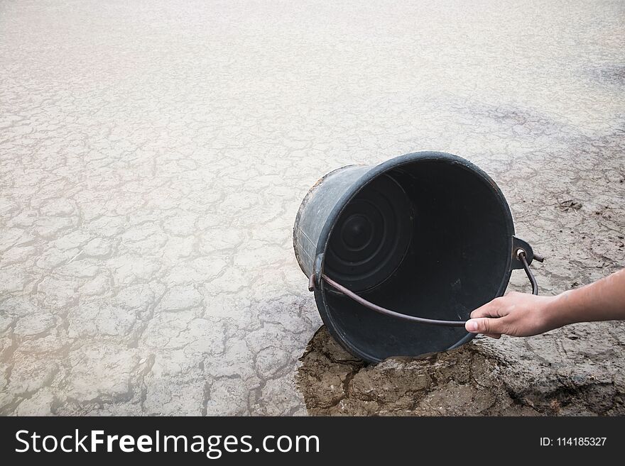 Woman Hand Are Scooping Water On Cracked Ground.