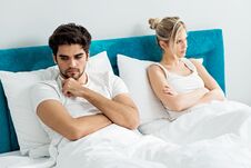 Young Couple On The Bed; Problems In The Bedroom Royalty Free Stock Photography