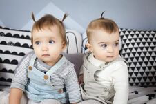 Little Sisters Sit On Bed Royalty Free Stock Images
