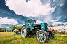 Old Tractor Parking In Backyard In Summer Sunny Day. Special Agricultural Equipment. Royalty Free Stock Image