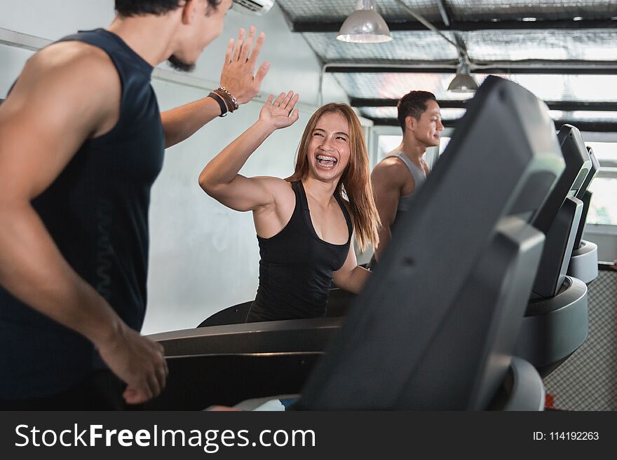 Asian Young Beautiful Woman Exercising On Treadmill