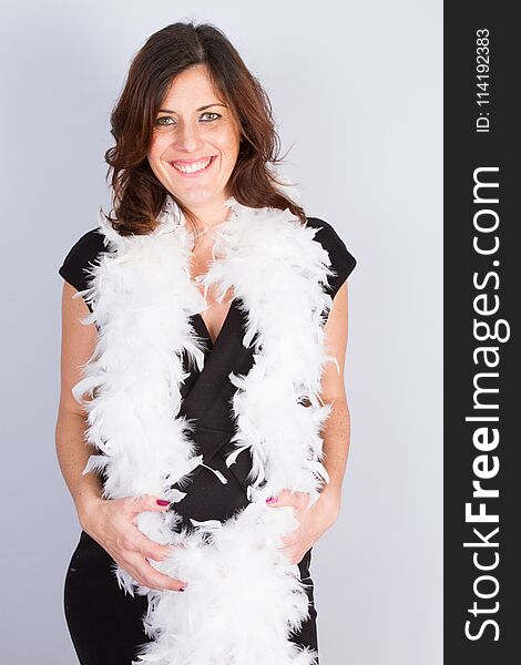 A Pregnant Woman Standing With Feather Boa