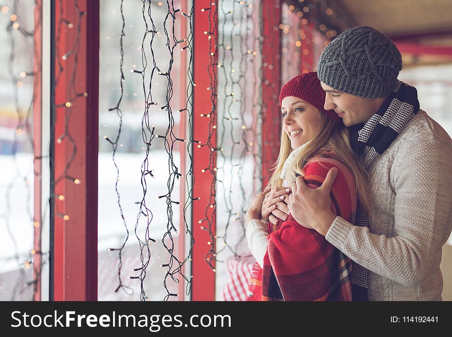 Young couple in love at the window