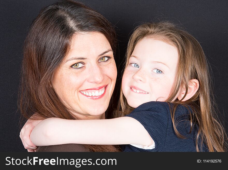 Happy smiling mother and daughter embracing