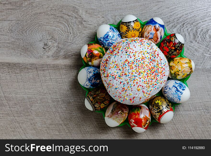 Easter bread with white icing and eggs lined in a circle on a wooden background. Easter bread with white icing and eggs lined in a circle on a wooden background.