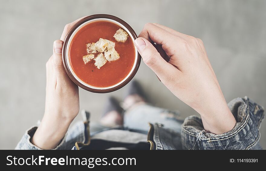 Woman Holding Tomato Soup Cup With Croutons