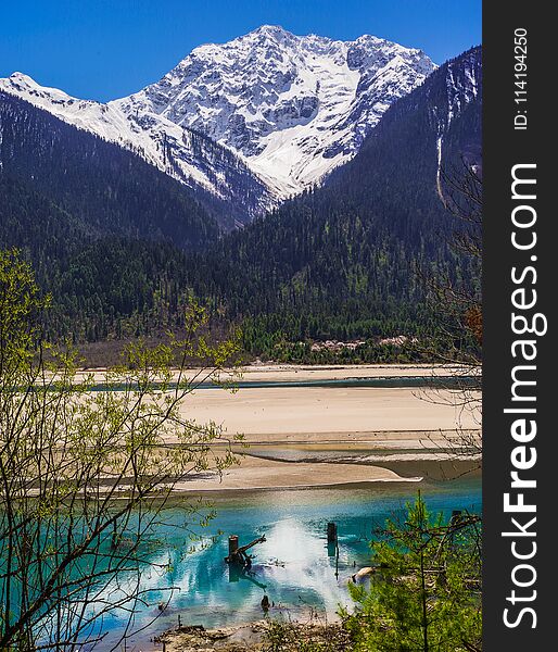 Green water , snow mountain , white clouds , landscape of canyon in SiChuan province , China. Green water , snow mountain , white clouds , landscape of canyon in SiChuan province , China