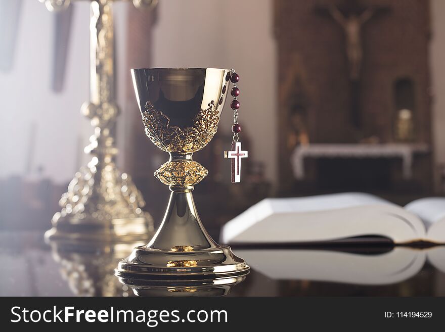 Holy communion concept. The Cross, Holy Bible, rosary and golden chalice. Holy communion concept. The Cross, Holy Bible, rosary and golden chalice.