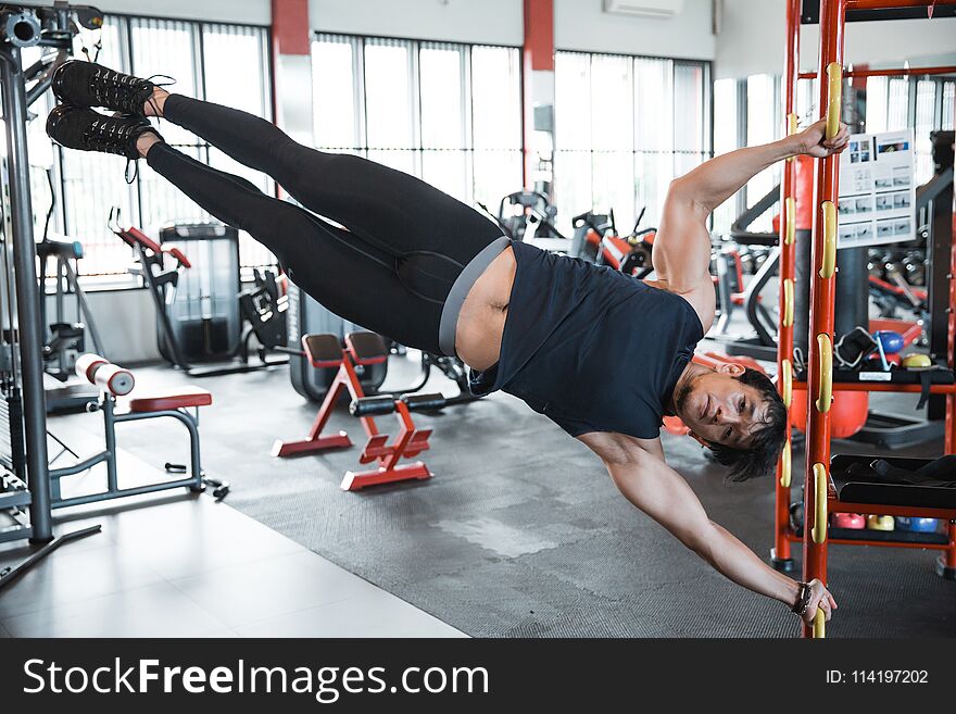 Man doing human flag exercise in a gym