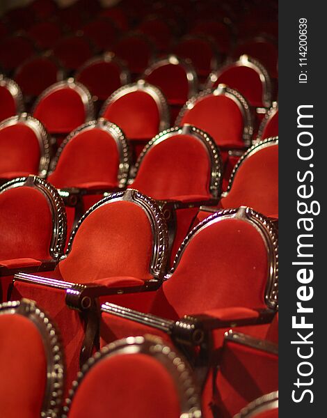 Rows of red chairs in the theater