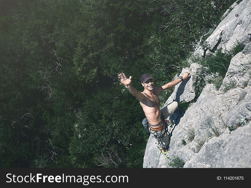 Man rock climber climbs on the cliff