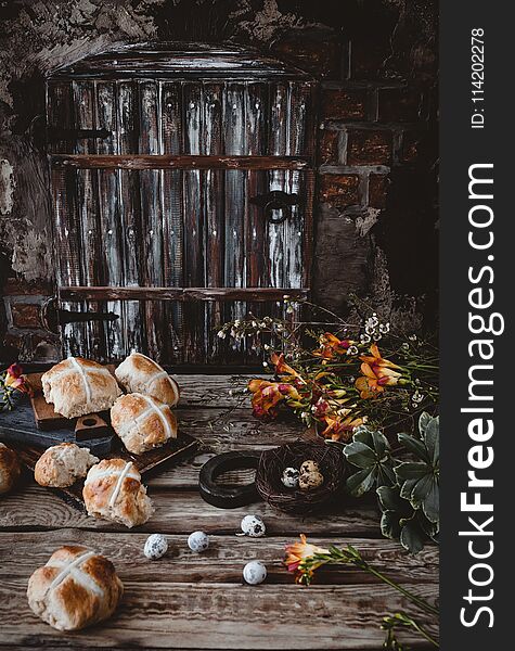 Easter table with hot cross buns and flowers