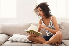 Young Thoughtful Woman With Book Stock Photo