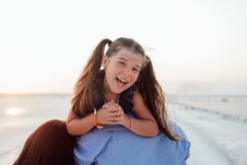 Young Happy Family Walking Along The Seashore. Little Girl. Smiling. Long Hair. Royalty Free Stock Image