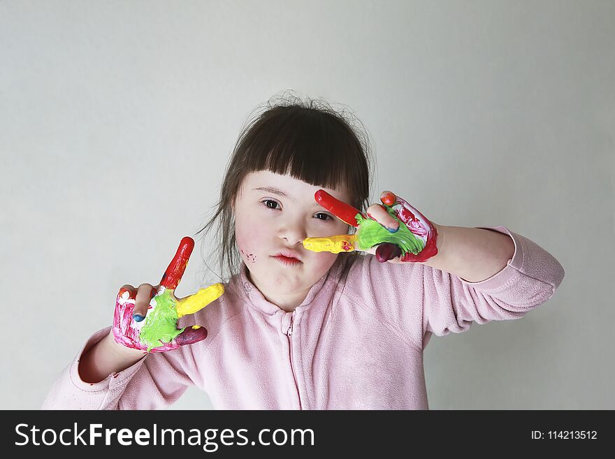 Cute little girl with painted hands. on grey background. Cute little girl with painted hands. on grey background.