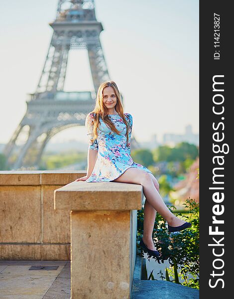 Girl in blue dress near the Eiffel tower, Paris
