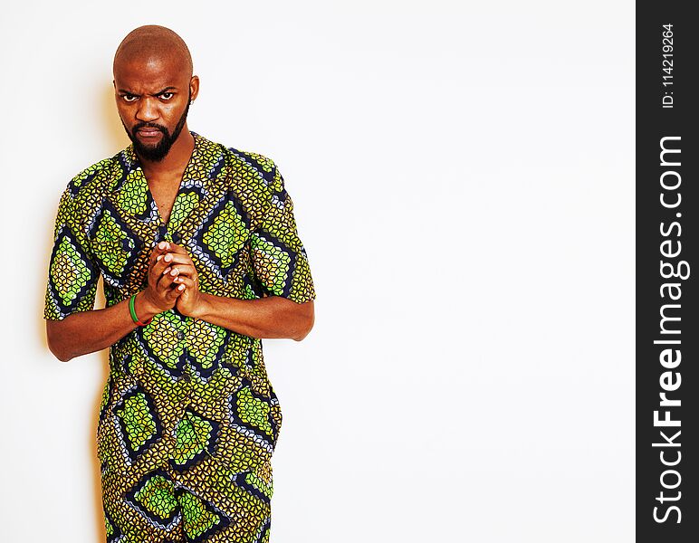 Portrait of young handsome african man wearing bright green national costume smiling gesturing, entertainment stuff