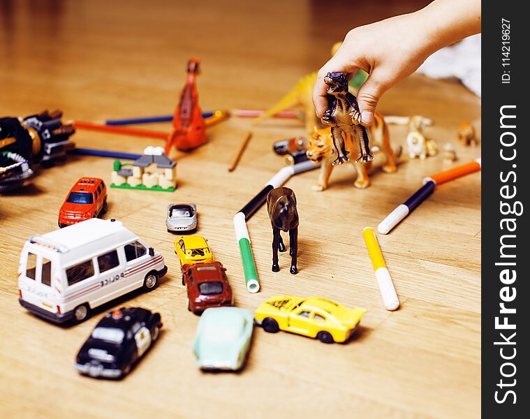 Children playing toys on floor at home, little hand in mess, free education, lifestyle people concept