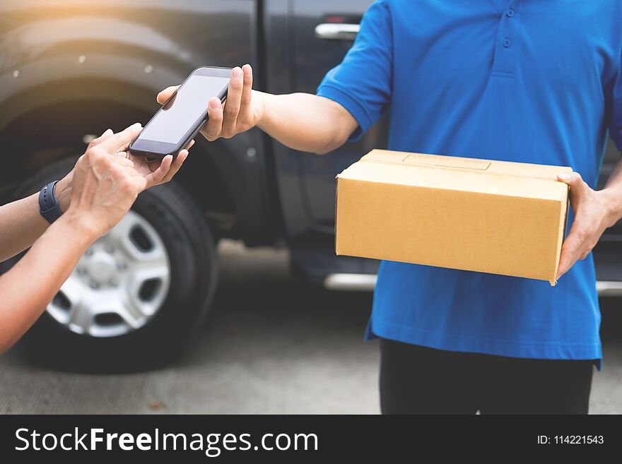 messenger man hold box and talk on smart phone and payment terminal in hands, Package delivery concept.