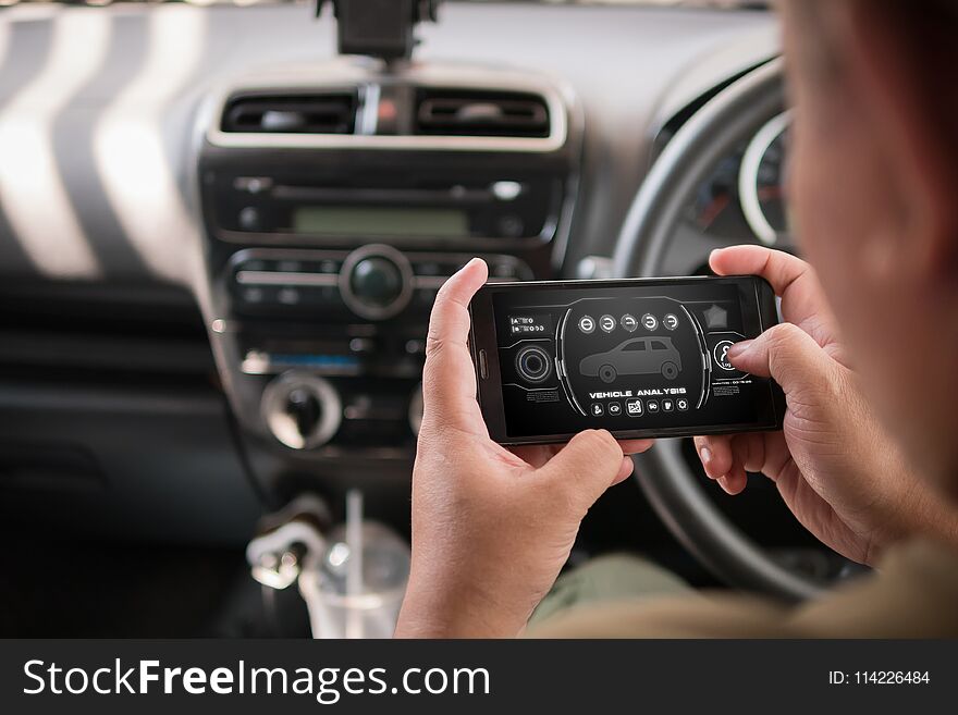 Hands of man using mobile smart phone vehicle analysis appiication in the car for mobile technology application concept