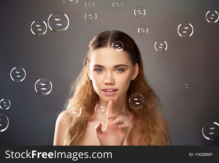 Portrait of young beautiful girl in Studio, with professional makeup. Beauty shooting.Bubble. Atmosphere of lightness, childhood
